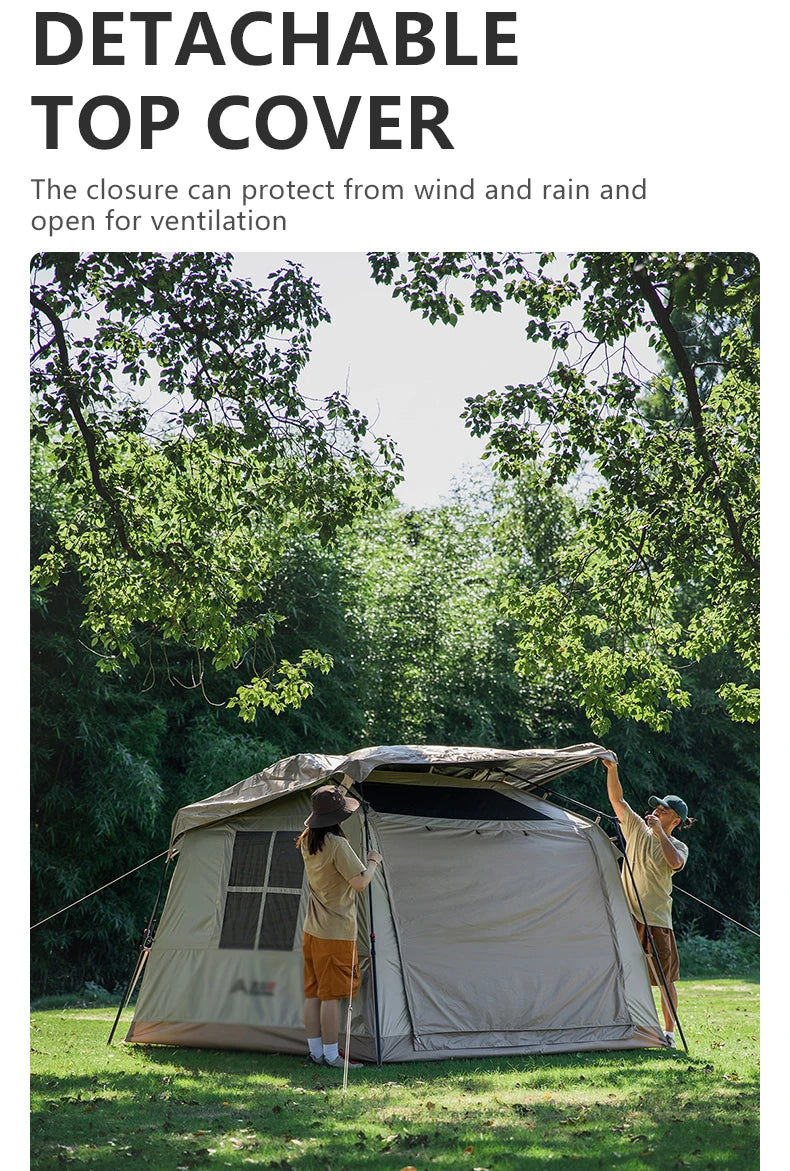 Two campers lifting the detachable top cover clear of the pitched tent on a grassy site.