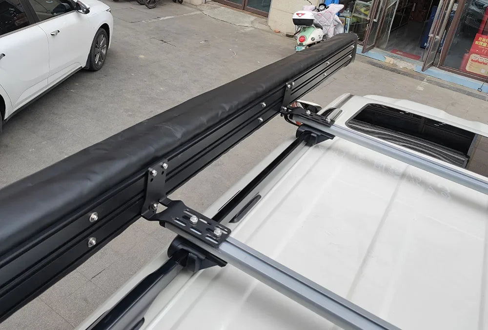 Close-up of the stowed awning bag bolted to a vehicle's roof rails