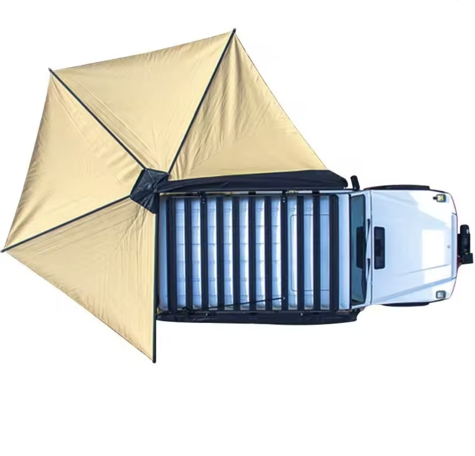 Overhead view of the khaki canopy fanned out from a white pickup's roof rack