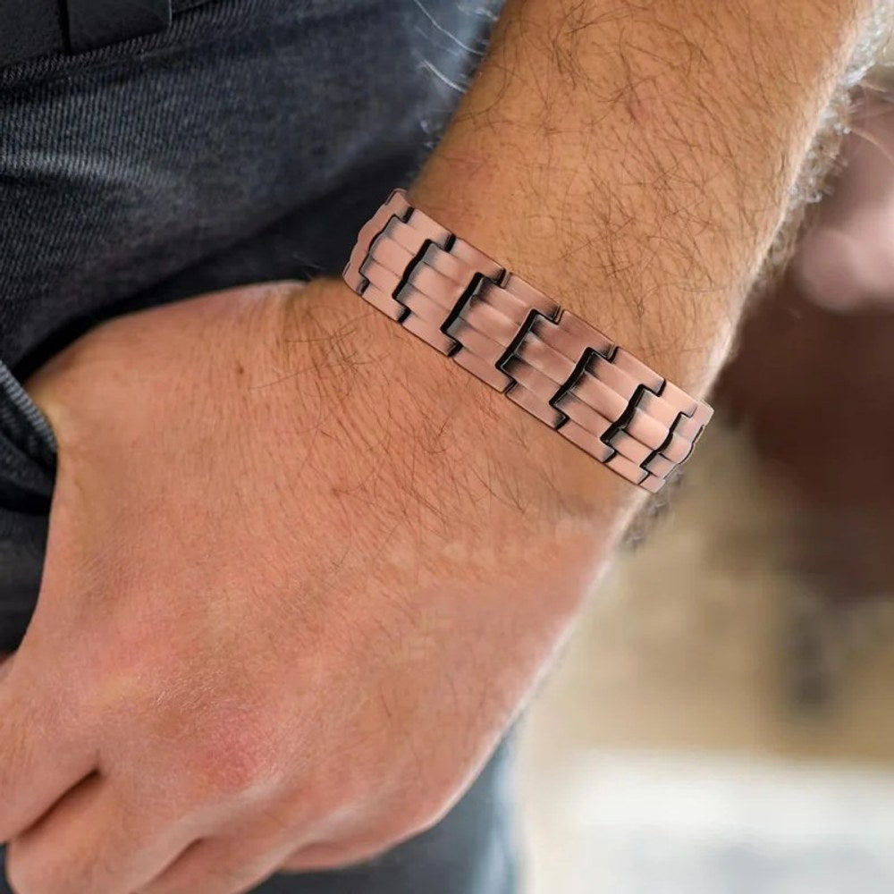 Wide copper link bracelet worn on a man's wrist