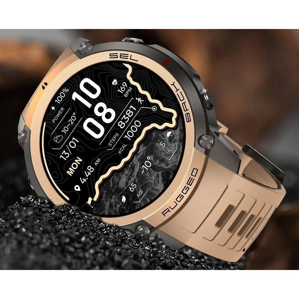 DM59 GPS smartwatch with a gold bezel and sand-coloured silicone strap, set in black gravel