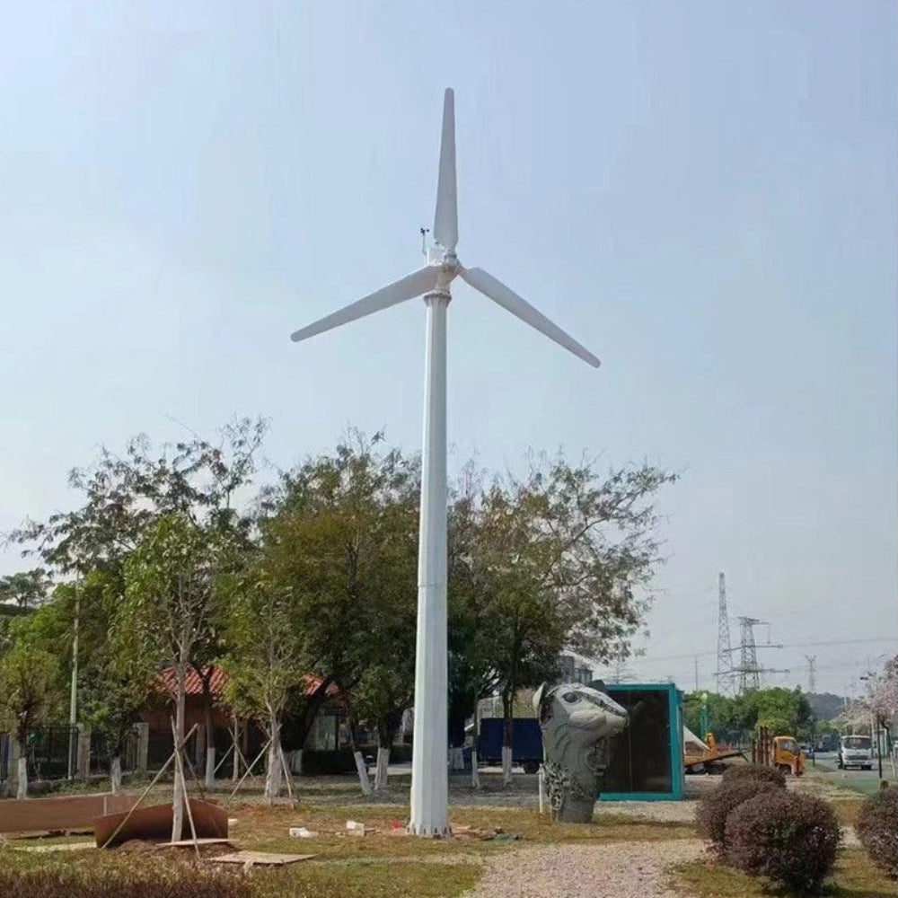 G Type horizontal wind turbine on a tall white ground mast above parkland trees - representative family photo