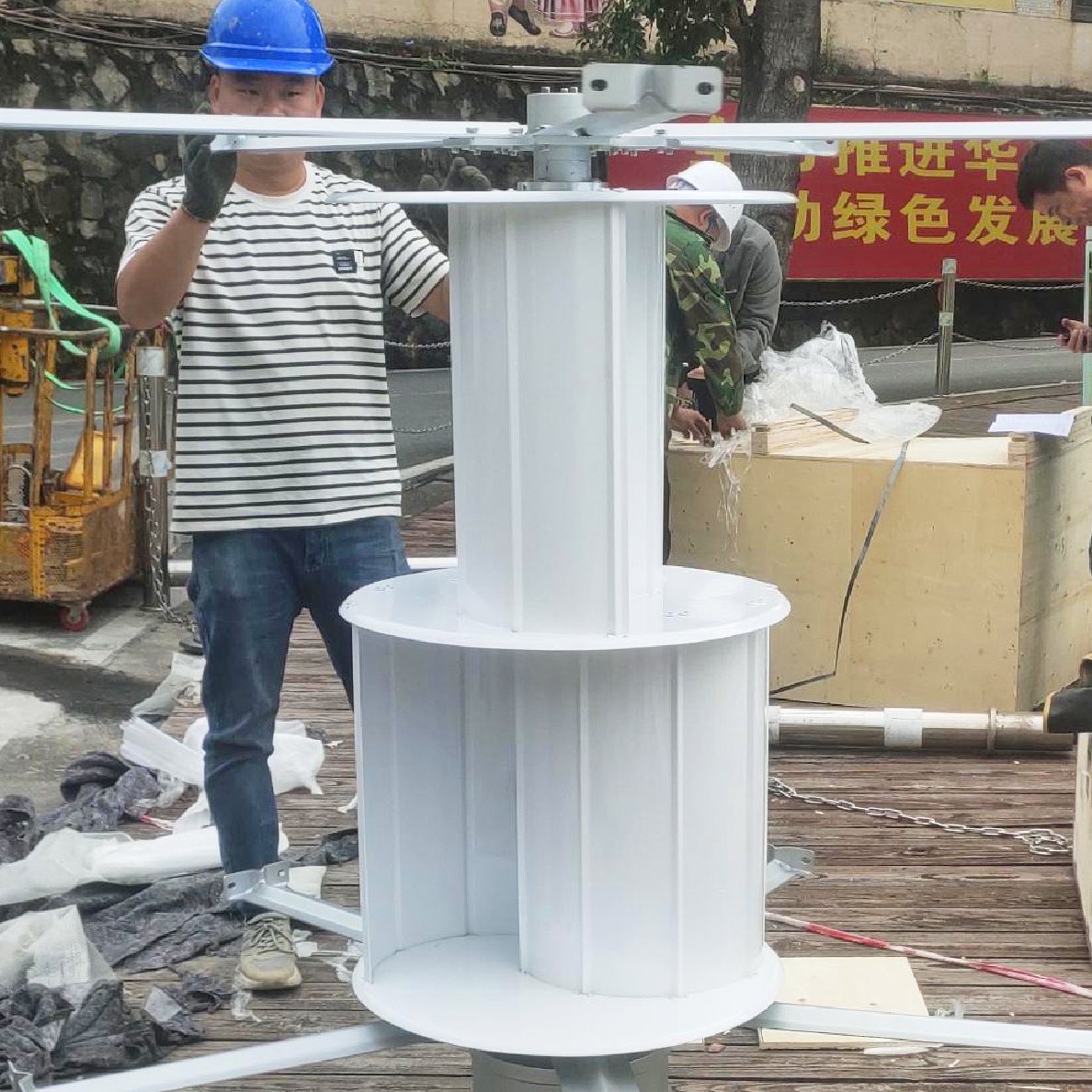 H1000 rotor assembled on the ground — five white aluminium blades around the central assist wind wheel