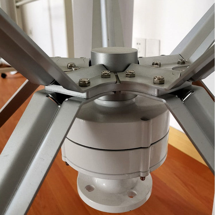 Close-up of the H12 generator housing and bolted blade-arm hub beneath the five-blade rotor - representative family photo