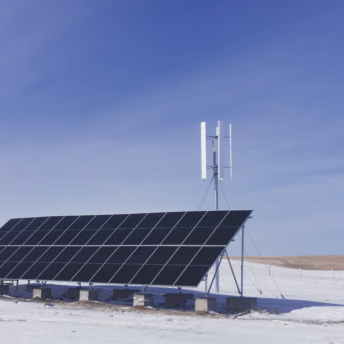 H2000 turbine and a ground-mounted solar array on a snowy plain