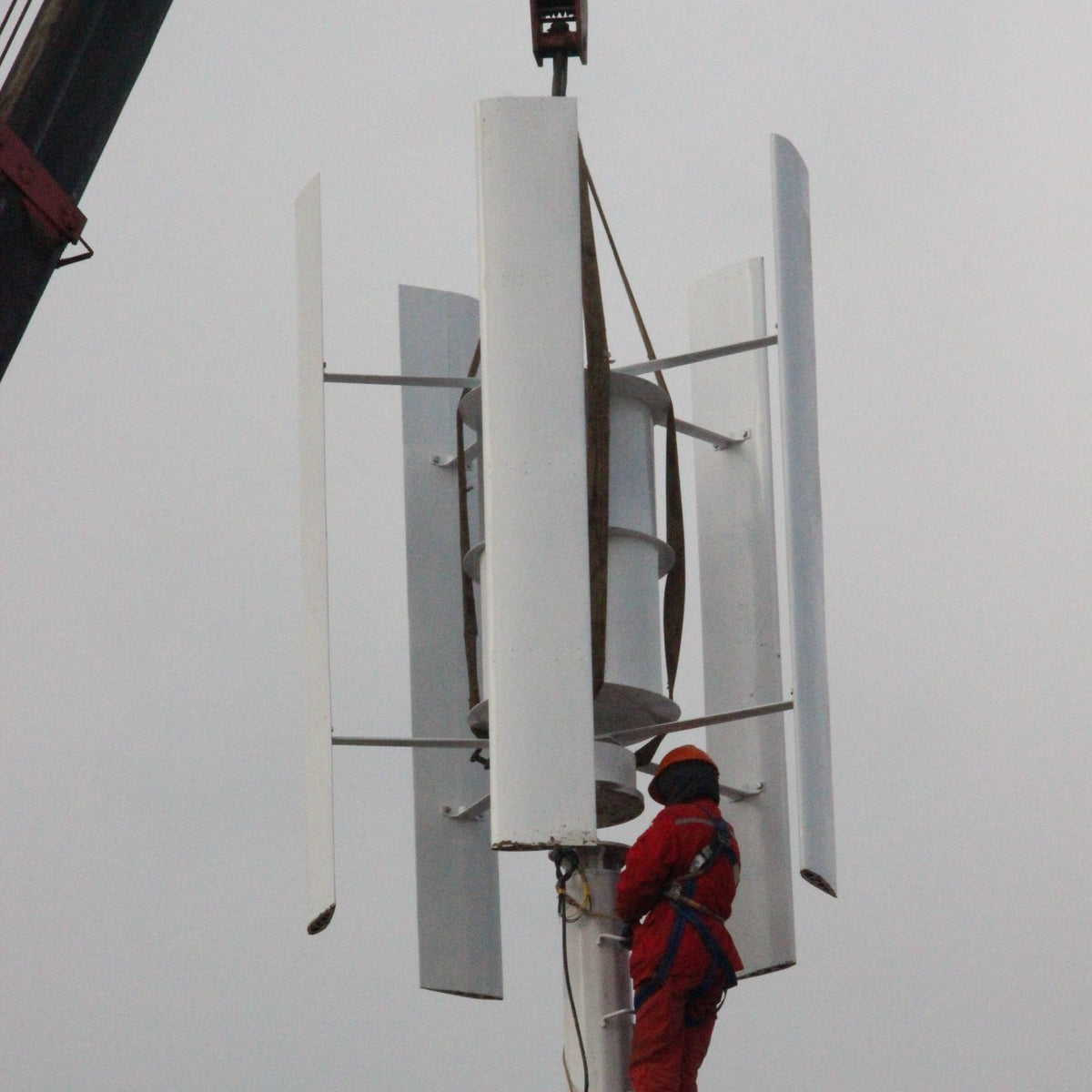 Technician at the top of the mast fitting the H2000 blades