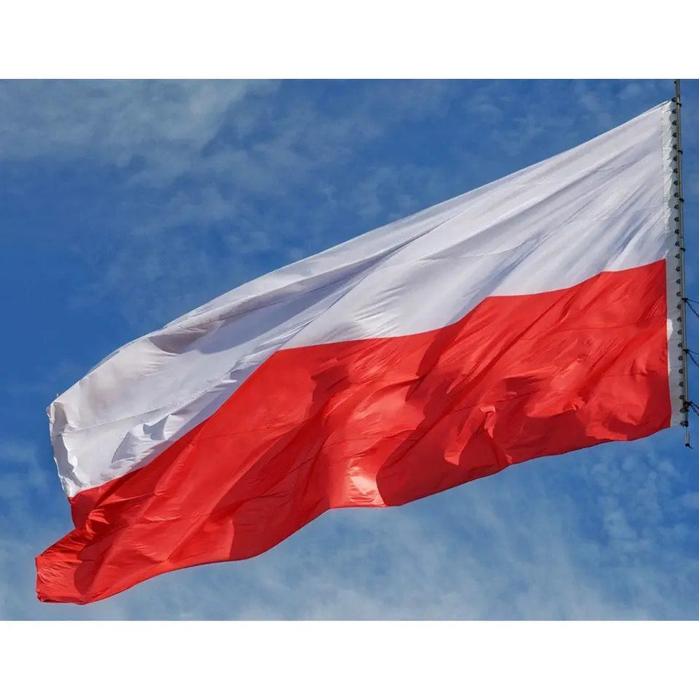 Polish flag in printed polyester flying against blue sky: white over red
