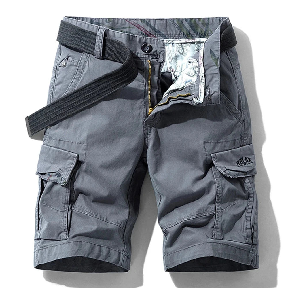 Grey RELAX six-pocket cargo shorts laid flat, front view, fly open to show the printed inner waistband, RELAX embroidery on the right cargo flap, with a dark grey webbing belt used for styling