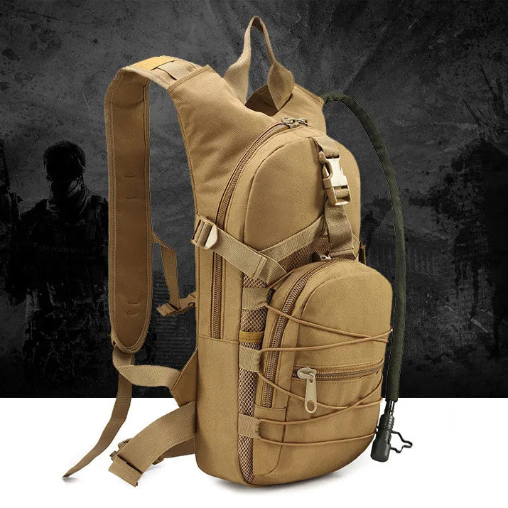 Tan tactical hydration pack, front three-quarter view, drinking hose fitted, dark backdrop
