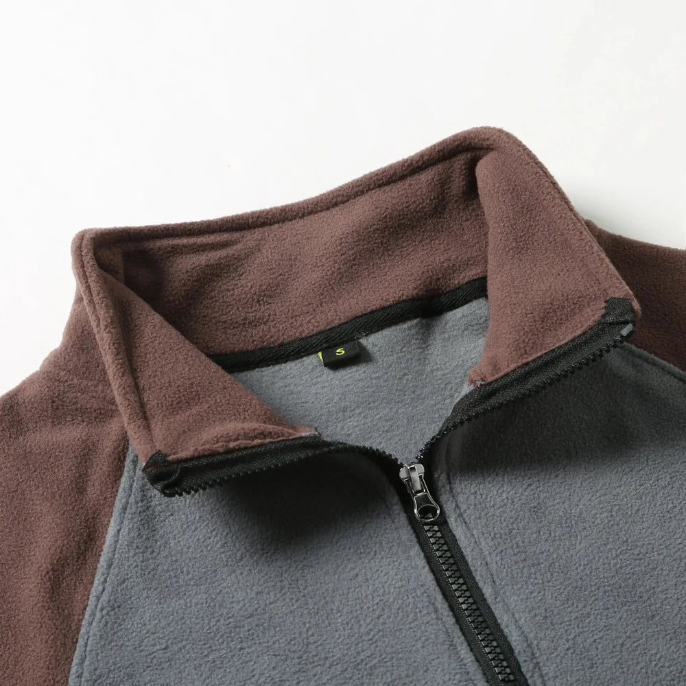 Close-up of the stand collar and half zip, coffee collar on a grey body