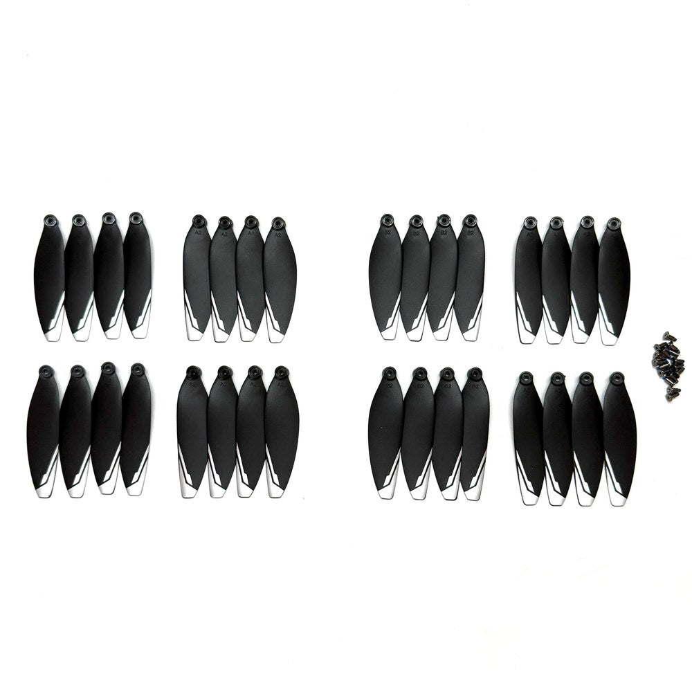 Thirty-two black XT606 drone propellers with white tips and their mounting screws