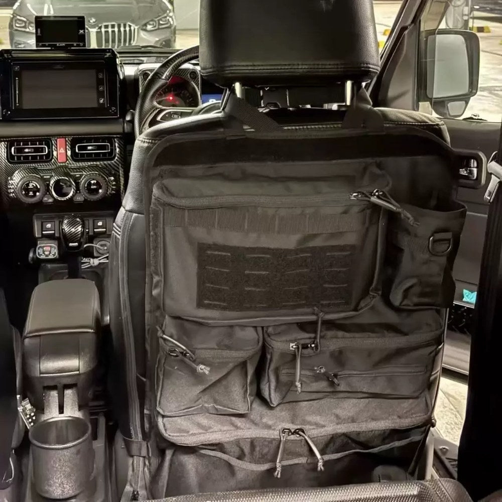 Black zipped seat back organiser strapped around the headrest of a right-hand-drive 4WD's front seat