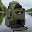 Green Bassdash fishing backpack photographed by the water with the lower tackle compartment open and empty