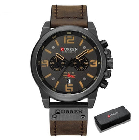 Black case with sand markers on a dark brown strap and CURREN box