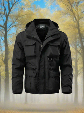 Black jacket front view, hood attached, storm flap closed over the main zip