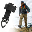 Black glove clip with swivel hook shown open, hiker on a ridge behind