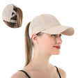 Beige cap worn with a ponytail through the back, inset shows the crossed straps