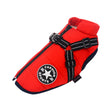 Red coat photographed flat showing the harness buckle and navy trimmed hem