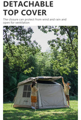 Two campers lifting the detachable top cover clear of the pitched tent on a grassy site.