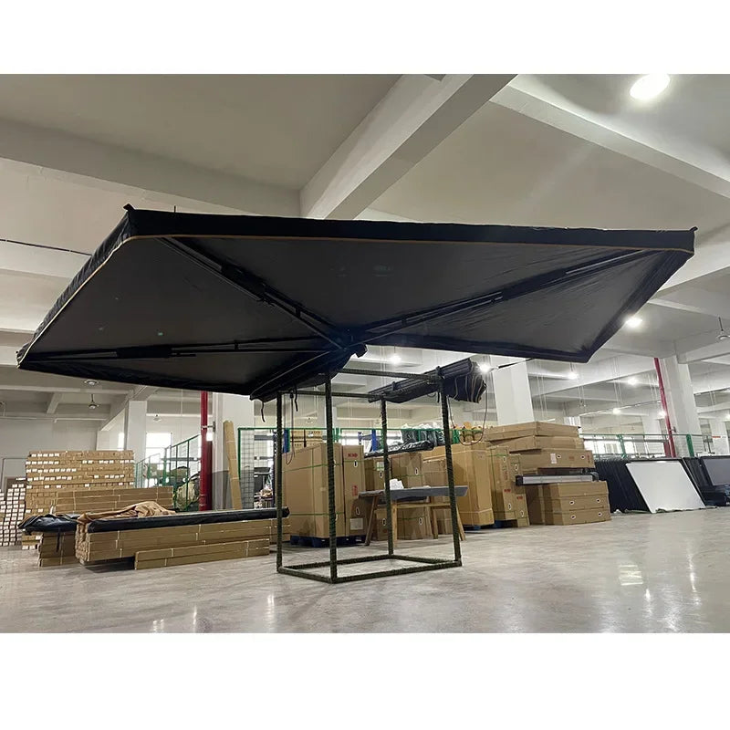 Side view of the black awning opened indoors on a display frame