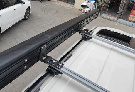 Close-up of the stowed awning bag bolted to a vehicle's roof rails