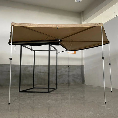 Khaki free-standing awning on poles, shown from the front against a plain wall