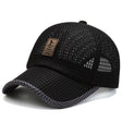 Black open-mesh cap with tan EDIKO badge and grey peak binding