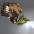 Camo LED cap facing right, five peak LEDs throwing a bright beam across a grey studio backdrop