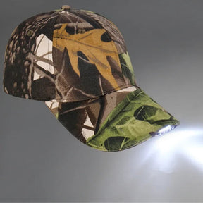 Camo LED cap facing right, five peak LEDs throwing a bright beam across a grey studio backdrop