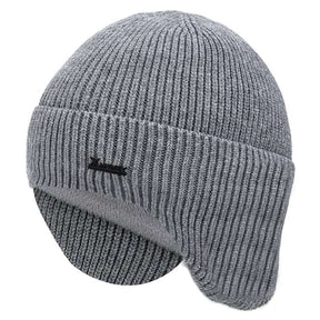 Light grey wool beanie from the side with earflaps down, showing the folded cuff and ribbed crown