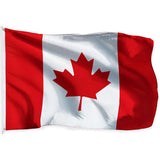 Canadian flag in printed polyester: red maple leaf on white; white header strip with metal eyelets at left