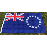 Cook Islands flag in printed polyester laid flat on grass: Union Jack and a ring of white stars on blue