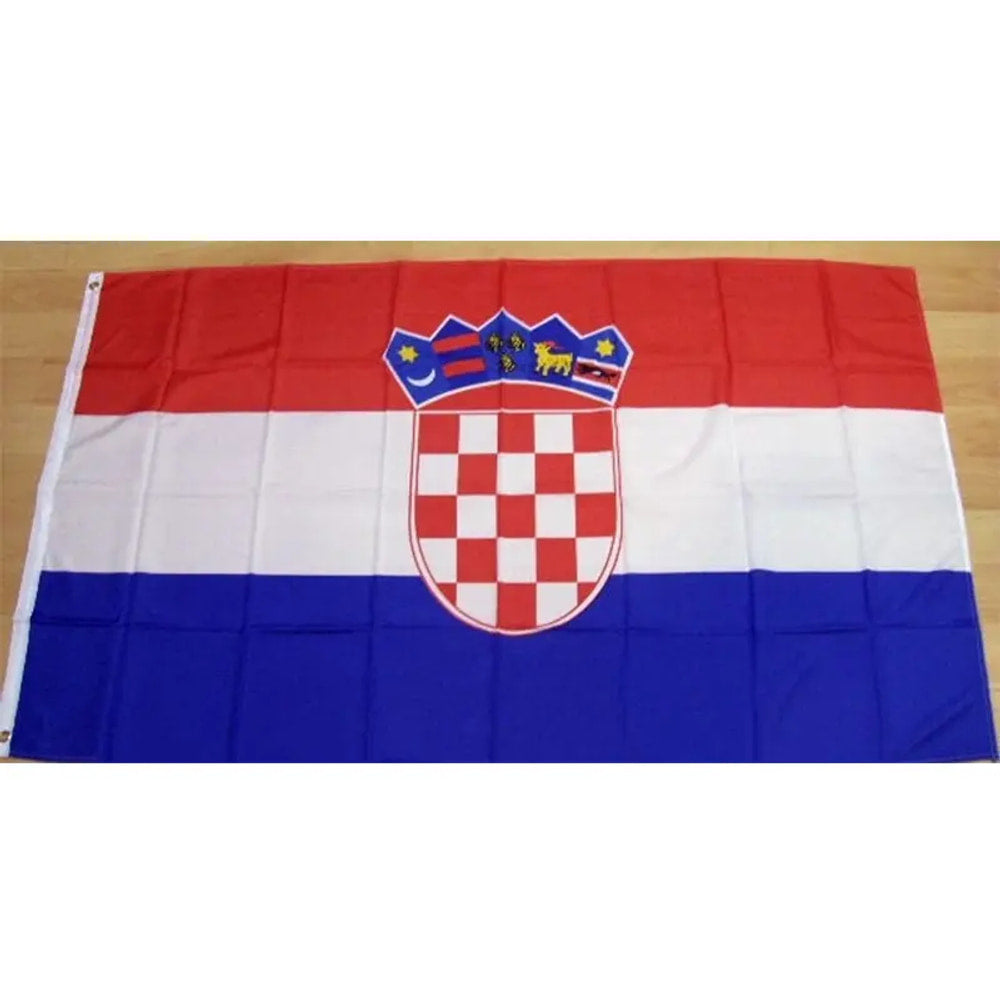 Croatian flag in printed polyester laid flat on a wooden floor, red, white and blue with the chequered shield
