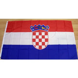 Croatian flag in printed polyester laid flat on a wooden floor, red, white and blue with the chequered shield