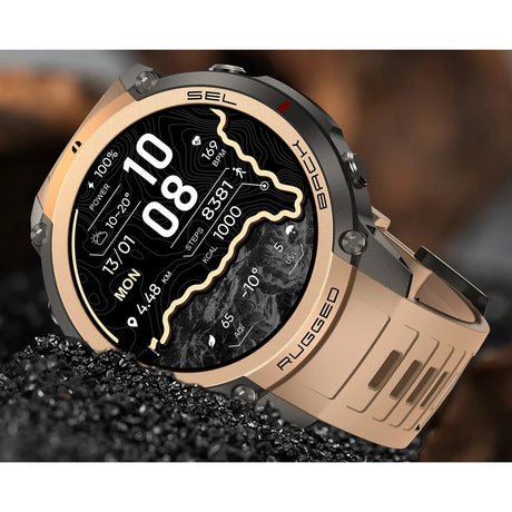 DM59 GPS smartwatch with a gold bezel and sand-coloured silicone strap, set in black gravel