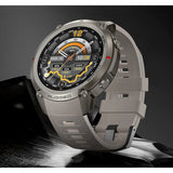 DM59 GPS smartwatch in grey with a grey silicone strap, standing on a dark rock