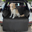 Golden retriever in a harness sitting on the black-edged cargo liner fitted in the back of a white SUV, bumper flap down