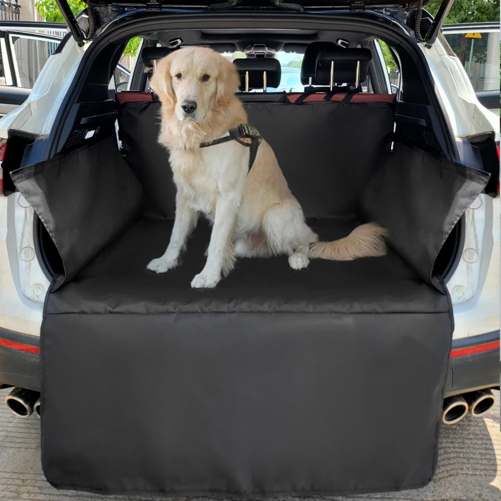Golden retriever in a harness sitting on the black-edged cargo liner fitted in the back of a white SUV, bumper flap down