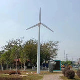 G Type horizontal wind turbine on a tall white ground mast above parkland trees - representative family photo