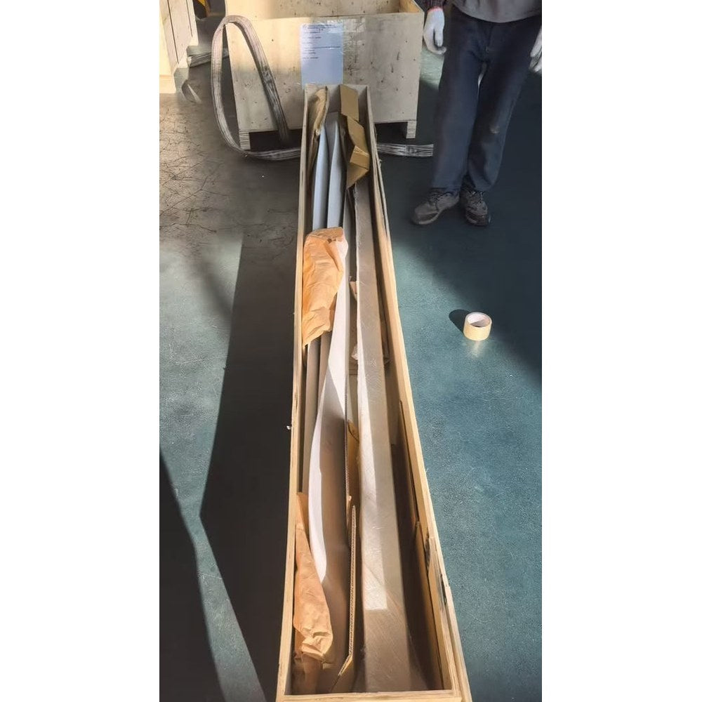 G-5000 wind turbine blades packed in paper and cardboard in a long plywood shipping crate on the factory floor