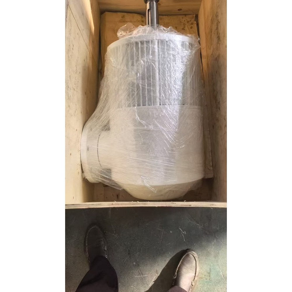 G-5000 wind turbine generator wrapped in plastic film inside its plywood shipping crate at the DHC factory