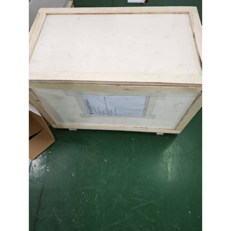 Closed plywood shipping crate for a G-5000 wind turbine with the consignment label taped to its side