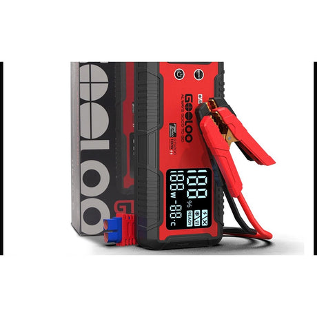 GOOLOO GT4000 12V jump starter standing beside its box with the red and black clamps attached