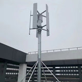 Five-blade H12 vertical axis wind turbine pole-mounted on a building rooftop under an overcast sky - representative family photo