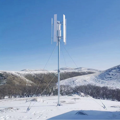 Five-blade H12 vertical axis turbine on a guyed steel mast in snow-covered hill country - representative H-series photo.