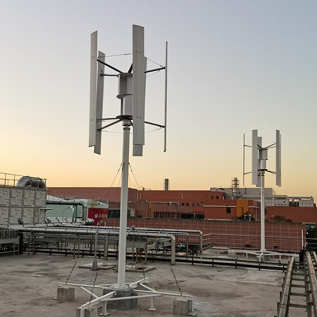 Two five-blade H12 vertical axis wind turbines on braced masts at an industrial site at sunset - representative family photo