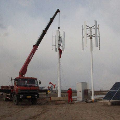 Crane raising an H2000 beside a second installed turbine at a solar site