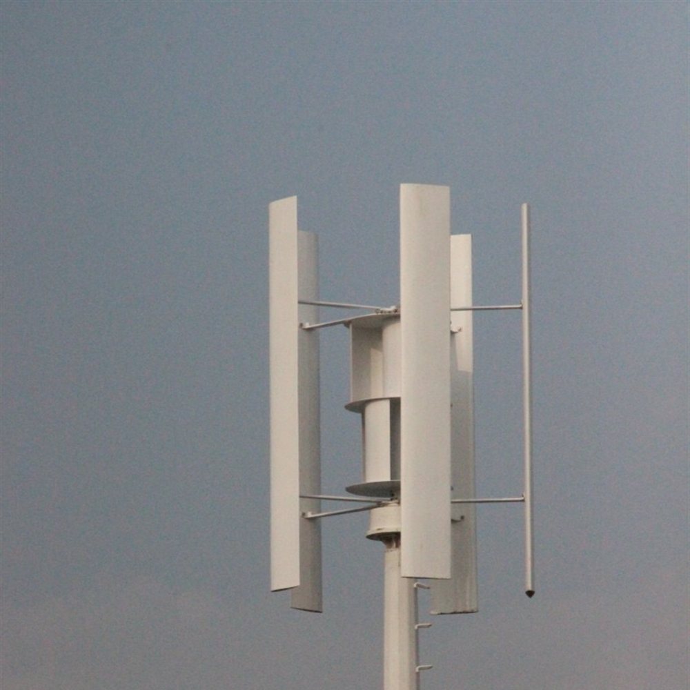 H2000 vertical axis wind turbine on a tall white mast against an overcast sky