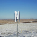 H2000 vertical axis wind turbine on a mast in an open snow-covered field