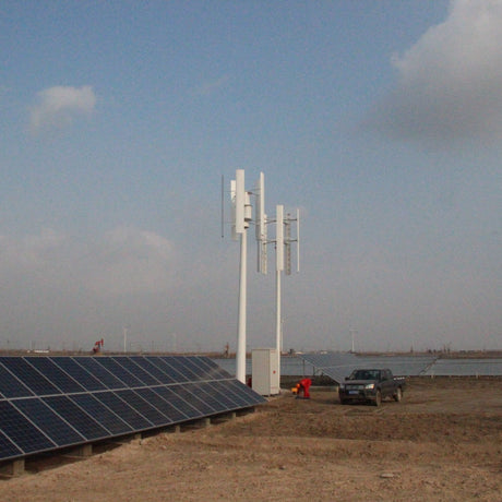 H2000 vertical wind turbines standing over a row of solar panels